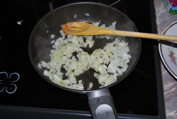 Сковороду разогрейте, добавьте масло и лук. Обжаривайте около 8-ми минут, помешивая.